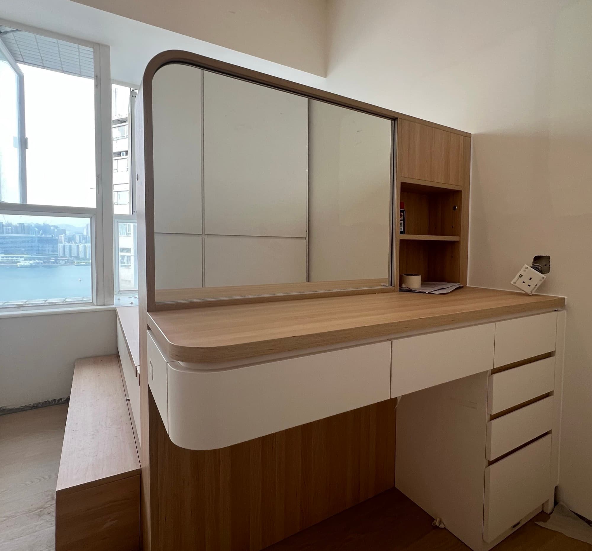 The dressing table as built, with its sliding mirror and curved oak counter, harbour visible through the window