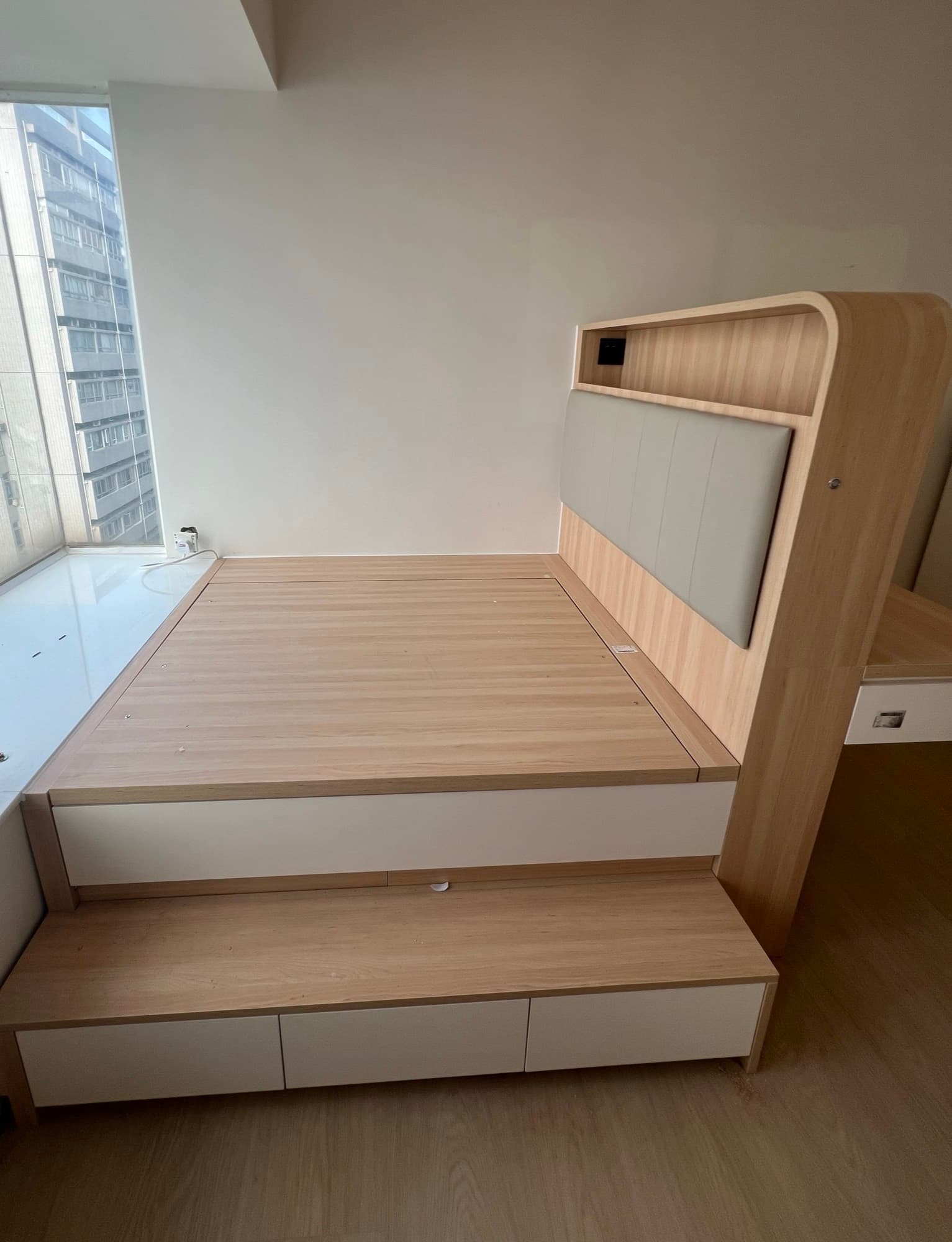 The platform bed as built: drawer base, drawer step and curved oak headboard installed on site